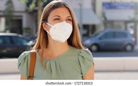 COVID-19 Pandemic Coronavirus Woman in city street wearing KN95 FFP2 mask protective for spreading of disease virus SARS-CoV-2. Girl with protective mask on face against Coronavirus Disease 2019. - Powered by Shutterstock