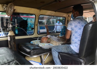 A Covid-19 patient waits inside an ambulance in front of DNCC Covid-19 Dedicated Hospital for admission to get treatment during the coronavirus pandemic in Dhaka, Bangladesh, on July 7, 2021. - Shutterstock ID 2003835422