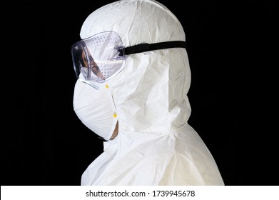 Covid-19 Protective Equipment. Side View Portrait Of Doctor Or Male Nurse Wearing Personal Protective Equiment On Black Isolated Background .