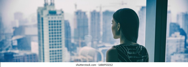 COVID-19 Quarantine Mental Health. Woman Self Isolated At Home Pensive Looking Out Of High Rise Building Window At City Skyline Thinking Of Relationship, Employment, Coronavirus. Panoramic Banner.