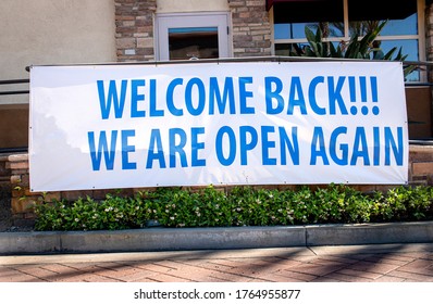 COVID-19 Related Sign At Restaurant Stating Welcome Back We Are Open Again