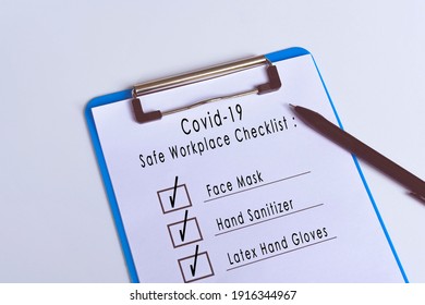 Covid-19 Safe Workplace Checklist Attached On Blue Clip Board And Pen. Workplace Safety Concept