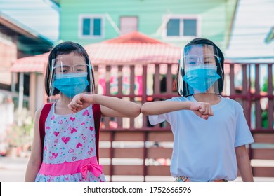 Covid-19 Safety And Social Distancing Concept, Kids Greeting Elbow Touch Elbow Before To Classroom, Asian Kid Back To School Of Thailand, Cute Children Smile Under Mask And Face Shield For Protect.