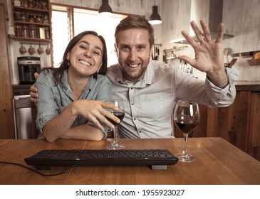 COVID-19 Second Wave And Virtual Fall And Winter Celebrations Concept. Screen View Of Happy Couple Video Calling Friends Using Laptop And Cheering With Wine Celebrating Christmas Virtually