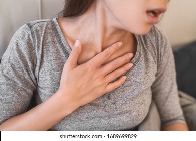 COVID-19 shortness of breath pneumonia woman with Corona virus symptoms such as, fever, body aches breathing difficulties. - Shutterstock ID 1689699829