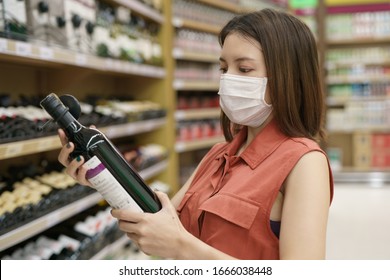 Covid-19 Spreading Outbreak. Woman In Medical Protective Mask Panic Buying Wine. Fear Of Coronavirus.