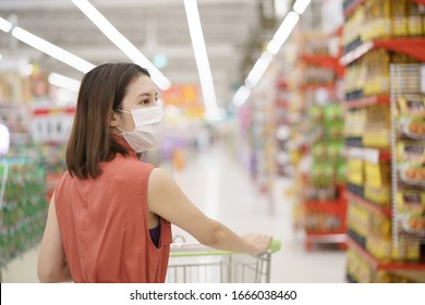 Covid-19 Spreading Outbreak. Woman In Medical Protective Mask Panic Buying Food. Fear Of Coronavirus.