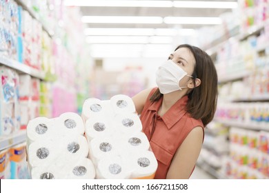 covid-19 spreading outbreak. Woman in medical protective mask panic buying tissue paper. Fear of coronavirus.