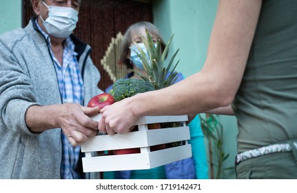 COVID-19 Stay home. Delivering grocery supply for elderly. - Shutterstock ID 1719142471