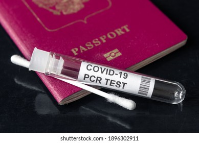 COVID-19, travel, test and safety concept, tube and swab for PCR testing and tourist passport. Corona virus diagnostics in airport due to restrictions. Kit for coronavirus check during pandemic.