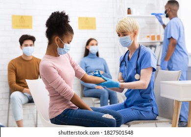 Covid-19 Vaccination. African American Teen Girl Receiving Coronavirus Vaccine Injection Shot In Arm Sitting With Doctor In Hospital. Corona Virus Medicine Treatment And Prevention. Selective Focus - Shutterstock ID 1827501548