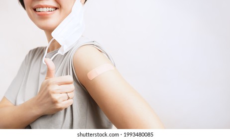 COVID-19 vaccination concept. A beautiful asian woman smiling and doing thumbs up after getting a Vaccine feeling okay and no side effect. Herd Immunity, Vaccinated, Protect, Hospital, Advertising
