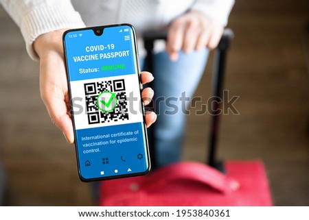 COVID-19 vaccination pass with green sign in mobile phone for travel, tourist shows health certificate app, digital pass in smartphone at airport. Concept of corona, immunity passport, test, tourism.