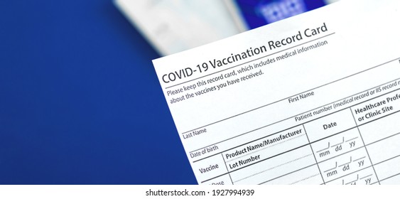 COVID-19 Vaccination Record Card Close Up On Table In Hospital, Banner