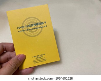 The Covid-19 vaccination record card issued by Taiwan Centers for Disease Control, Ministry of Health and Welfare holding on hand placing on the left of pic. 06-03-2021 Taipei, Taiwan