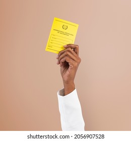 Covid-19 vaccine certificate mockup psd held by a businessman hand