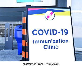 Covid-19 Vaccine Clinic Entrance. Close Up Of Immunization Clinic Sign Board At Building Of Government Vaccination Site. Public Health Care To Fight Against Coronavirus Infections.