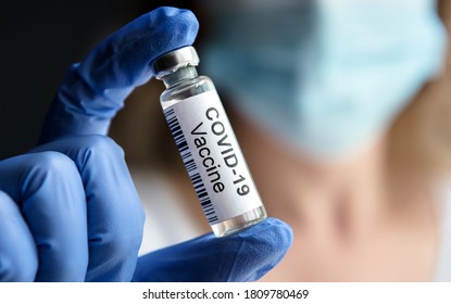 COVID-19 Vaccine In Doctor's Hand. Researcher Holds, Shows Corona Virus Vaccine For Shot Close-up. Concept Of COVID19 Vaccine Distribution, People Health, Spread Of Coronavirus In UK, USA And EU.