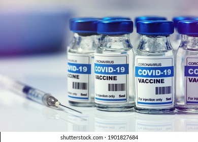 covid-19 vaccine - group of coronavirus vaccination vials and syringe - Shutterstock ID 1901827684