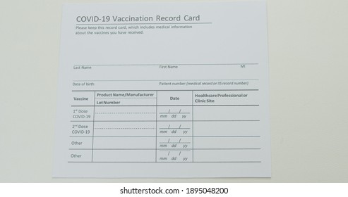 COVID-19 Vaccine Immunization Card. COVID-19 Vaccination Record Card Tracks Dose Of Coronavirus Vaccine. CDC And Dept. Of Defense Immunization Document.