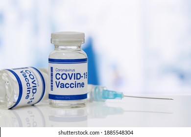 covid-19 vaccine in a medical research lab, a bottle of covid-19 vaccine, syringe for injection of vaccination, hand holding vaccine, covid-19 cure testing