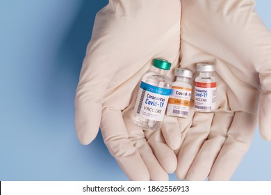 COVID-19 Vaccines For Developing Country Concept. Hand Of A Researcher Holding Coronavirus 2019-nCoV Vaccine Vials. Together, Financial Support Poor Nations, Alliance, Unicef, WHO, G20, Promised.