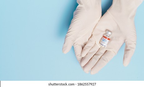 COVID-19 Vaccines For Developing Country Concept. Hand Of A Researcher Holding Coronavirus 2019-nCoV Vaccine Vial. Together, Financial Support Poor Nations, Alliance, Unicef, WHO, G20, Promised.