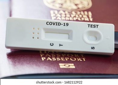 COVID-19 Virus Disease Rapid Testing, Coronavirus Crisis, Global Pandemic Outbreak, Quick Antigen Test, Airport Security Health And Safety Check Concept, Testing Kit On A Red Passport