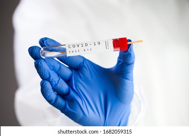 COVID-19 virus disease self swab test sample kit,UK NHS medical laboratory scientist holding plastic throat test swab viral specimen collection equipment tube,Coronavirus OMICRON PCR antigen check  - Shutterstock ID 1682059315