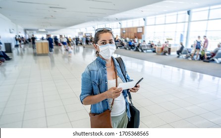 COVID-19 Worldwide Borders Closures.Traveler With Face Mask Stuck In Airport Terminal After Being Denied Entry To Other Countries. Passenger Stranded In Airport On His Travel Back To Home Country.