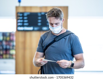 COVID-19 Worldwide Borders Closures.Traveler With Face Mask Stuck In Airport Terminal After Being Denied Entry To Other Countries. Passenger Stranded In Airport On His Travel Back To Home Country.