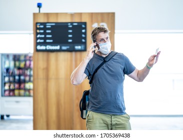 COVID-19 Worldwide Borders Closures.Traveler With Face Mask Stuck In Airport Terminal After Being Denied Entry To Other Countries. Passenger Stranded In Airport On His Travel Back To Home Country.