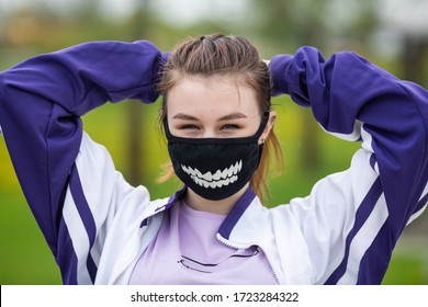 COVID-19. Young Caucasian Teen Girl In A Black Mask Goes In For Sports On A Street Sports Ground During A Pandemic. Coronavirus In Europe.