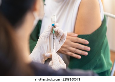 Covid-19,coronavirus, Elderly Asian Adult Woman Getting Vaccine From Doctor Or Nurse Giving Shot To Mature Patient At Clinic. Healthcare, Immunization, Disease Prevention Against Flu Or Virus Pandemic