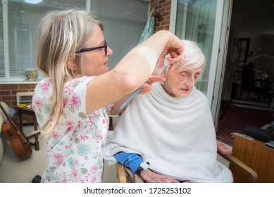 Covoid 19 Restrictions Means The Old Lady Cannot Be Taken To The Hair Dresser As Usual,so Her Visiting Carer Trims And Combs Her Hair For Her As It Gets Too Long.