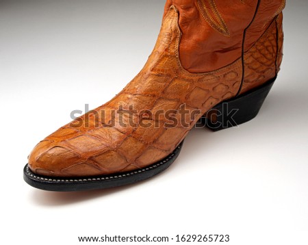 Cowboy boot made from the skin of a pangolin, or scaly anteater (Manidae species). All species of pangolins are threatened with extinction due to illegal hunting and trade
