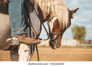 Cowboy Boot With A Spur. Ranch Horse. Pinto Western Horse With A Rider.