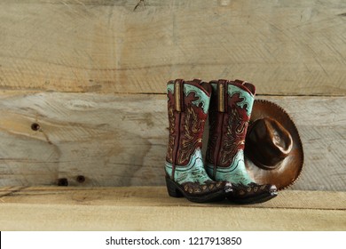 Cowboy Boots And Hat On A Natural Wood Background With Writing Space