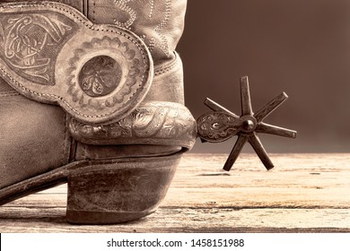 Cowboy boots and  Mexican spurs in black and white sepia tone with room for your type.