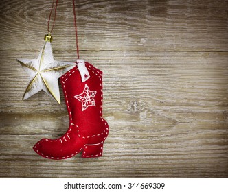 Cowboy christmas background with western toys boot and star on old wood texture