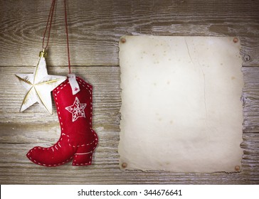 Cowboy christmas background with western toys boot and star on old paper texture for text