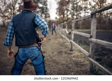 Cowboy With Gun Prepares To Gunfight, Back View