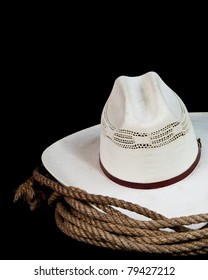 A Cowboy Hat And Lasso On A Black Background