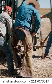 a cowboy in his chaps doin ranch work - Shutterstock ID 2117073017