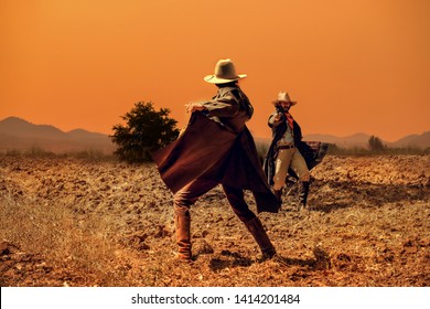 Cowboy Life: pistol shooting in a cowboy action shooting competition under sunset ,duel between cowboys. affair of honor