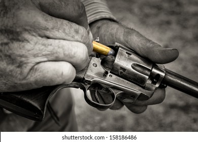 Cowboy Loading a Gun