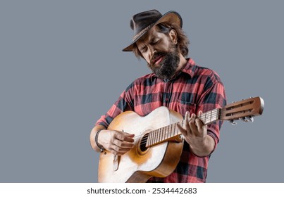 Cowboy playing guitar, singer, sing. Man cowboys playing acoustic guitars in wearing cowboy hat. Country guitarist isolated on gray. Male in cowboys hat plays guitar the singer sings. - Powered by Shutterstock