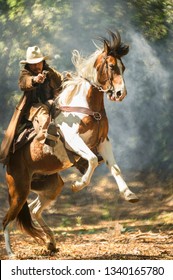 Cowboy Riding A Horse Carrying A Gun