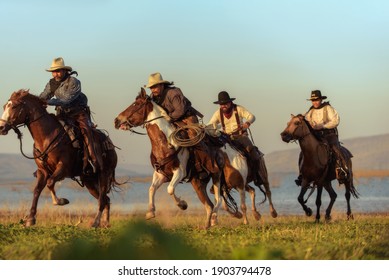 Cowboy riding a horse carrying a gun