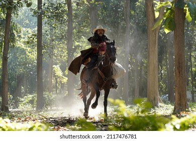 Cowboy riding horse in the forest.